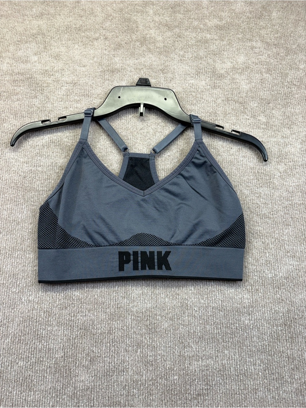 Victoria's Secret PINK seamless sports bra featuring a prominent black "PINK”. S